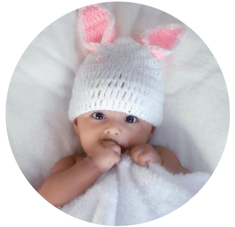 A sleeping baby wearing a bunny hat