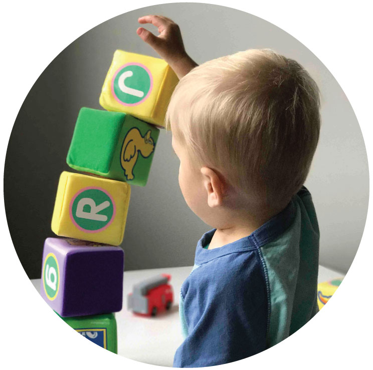 A baby playing with building blocks